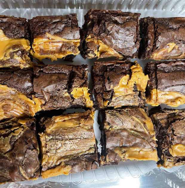 Our Chocolate Peanut Brownie is our signature brownie filled with Reese cups and topped with peanut butter. This Chocolate Peanut Butter Brownie is Heaven sent.